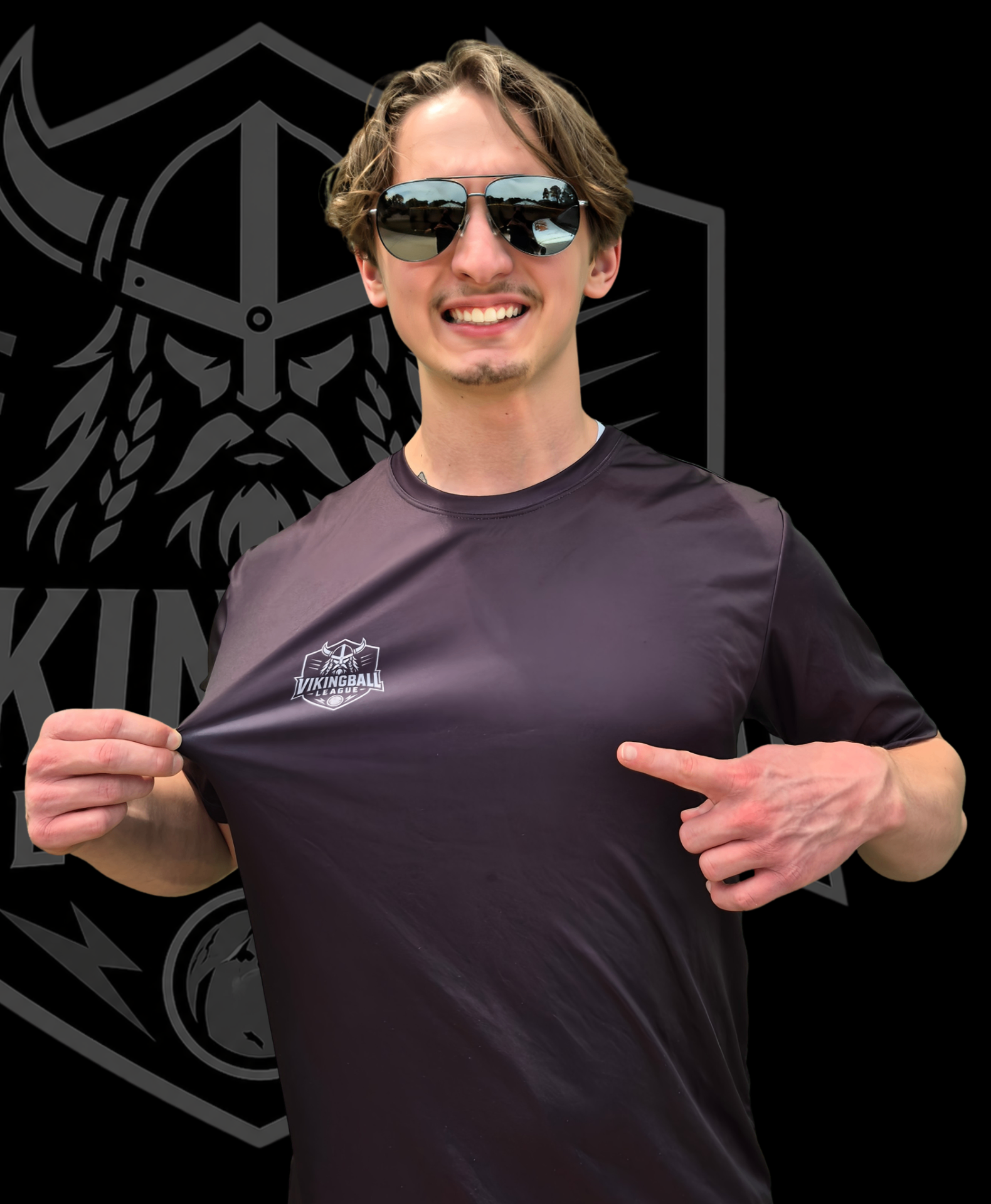 David Weiss, founder and head referee of Vikingball League, standing in front of the Vikingball logo